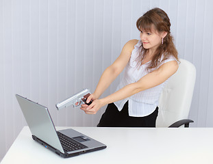 Image showing Woman fired a pistol at computer screen