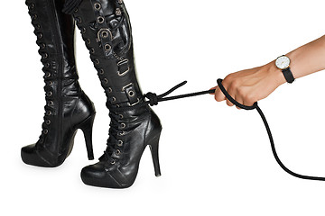 Image showing Male hand pulling a rope tied to female leg