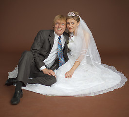 Image showing Happy newly-married couple on brown background
