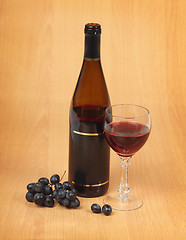 Image showing Bottle, glass and grapes on wooden background