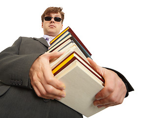 Image showing Man in dark glasses holding a books