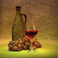 Image showing Dark Still Life - clay bottle, glass and grapes