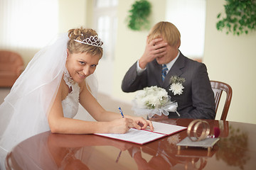 Image showing Marriage registration. Bride is happy. Groom in grief.