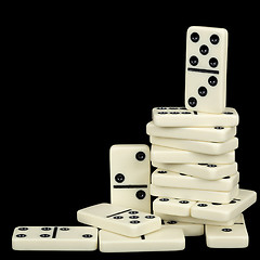 Image showing Pile of dominoes isolated on black background