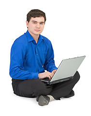 Image showing Businessman sits on a floor with the laptop