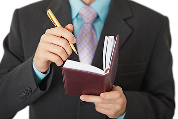 Image showing Business people record information in a notebook