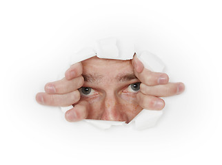 Image showing Man looks out from hole in white paper