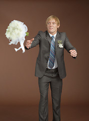 Image showing Groom catches a flying bouquet