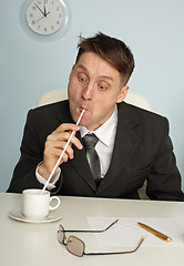 Image showing Comic man drinking coffee with long straws