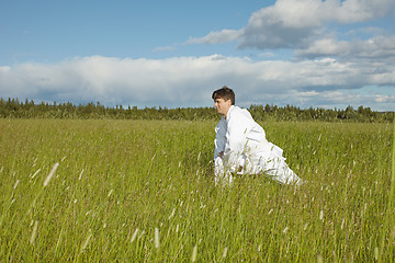 Image showing Man does exercises in field