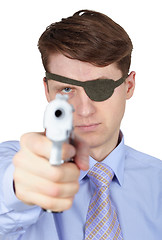 Image showing Portrait of young guy with eye-patch shooting a pistol