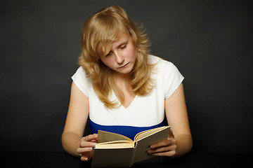 Image showing Woman reading book at night