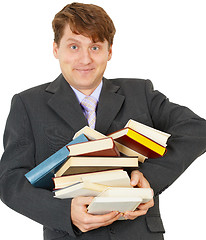 Image showing Happy man holding pile of books