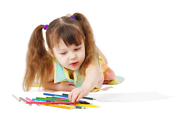 Image showing Child draws with color pencils on white