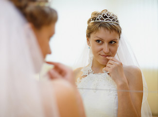 Image showing Bride admires himself in mirror