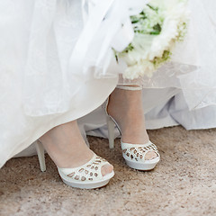 Image showing Shoes of bride under wedding dress