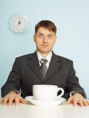 Image showing Businessman has drunk coffee and stare wide-eyes