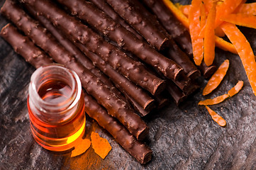 Image showing chocolate sticks with orange