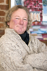 Image showing smiling senior middle age man with long hair