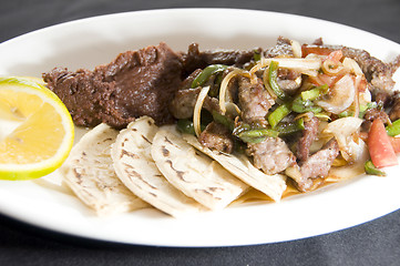 Image showing beef stir fry with mashed beans and tamales Nicaragua