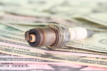 Image showing spark plug on dollar bills