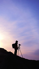 Image showing Silhouette of a photographer at sunrise