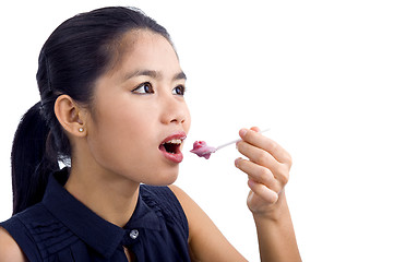 Image showing young beautiful woman eating yogurt