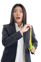 Image showing surprised businesswoman with ruler