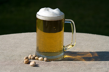 Image showing Mug of beer and nuts.