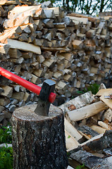 Image showing Axe and woodpile.