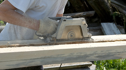 Image showing The person works as a power saw