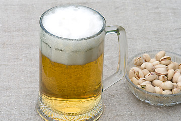 Image showing Beer and pistachios.