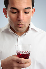 Image showing Man tasting red wine