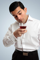 Image showing Man inspecting wine