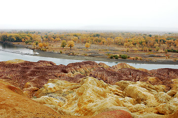 Image showing Colorful hills by the river