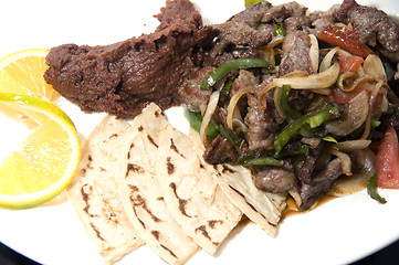 Image showing beef stir fry with mashed beans and tamales Nicaragua