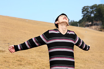 Image showing Carefree man standing in golden grass field being happy enjoying