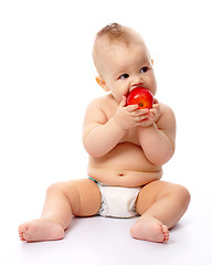 Image showing Little child is going to bite red apple
