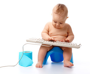 Image showing Little child is typing on keyboard