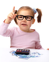 Image showing Little girl plays with money