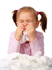 Image showing Little girl blows her nose