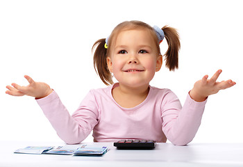 Image showing Little girl with few paper euro banknotes