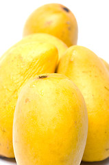 Image showing champagne mangos in plastic box white background