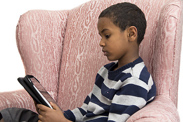 Image showing Young boy studying on a tablet PC