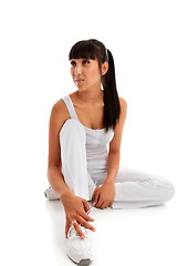 Image showing Young woman sitting wearing fitness exercise clothing.