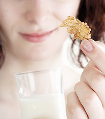 Image showing Young people eating milk with cereals