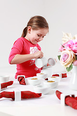 Image showing Girl helps to set table