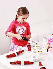 Image showing Girl helps to set table