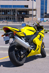 Image showing Yellow Motorcycle parked by the Construction