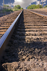 Image showing Railroad Tracks with Clouds in the Horizon